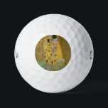 The Lovers Kissing Embrace by Gustav Klimt Golf Balls<br><div class="desc">Sunlight glints off the swirling golden embrace that surrounds the lovers in Gustav Klimt's masterpiece, The Kiss. The scene is a paradox of intimacy and isolation. The couple stands on a precipice, a field of colourful flowers at their feet, yet they are oblivious to the world around them. Their gazes...</div>