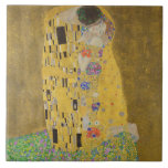 The Lovers Kissing Embrace by Gustav Klimt Tile<br><div class="desc">Sunlight glints off the swirling golden embrace that surrounds the lovers in Gustav Klimt's masterpiece, The Kiss. The scene is a paradox of intimacy and isolation. The couple stands on a precipice, a field of colourful flowers at their feet, yet they are oblivious to the world around them. Their gazes...</div>