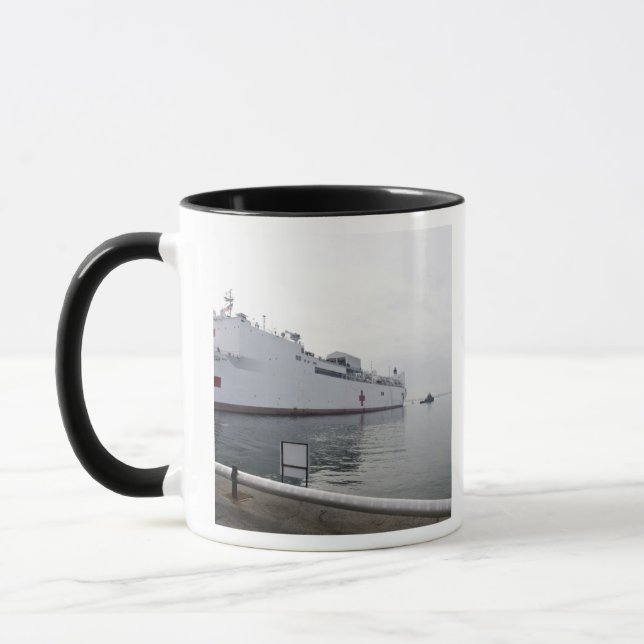 The Military Sealift Command hospital ship Mug (Left)