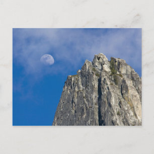 The moon rises and shines through the clouds postcard
