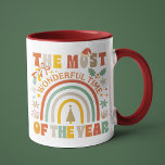 The Most Wonderful Time Of The Year Christmas Mug<br><div class="desc">The Most Wonderful Time Of The Year Retro Christmas Festive Holiday Mug features the text "The Most Wonderful Time Of The Year" in modern script typography accented with rainbow, Christmas tree, holly, Santa hat and snowflakes. Perfect for Christmas gifts, Christmas parties and holiday celebrations, birthdays and more. Created by Evco...</div>