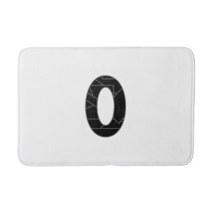 The number zero (0) in black bath mat