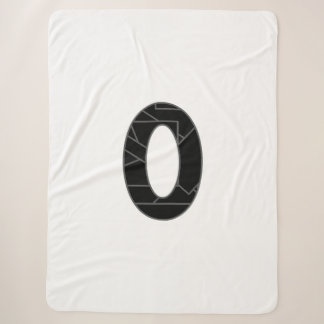 The number zero (0) in black sherpa blanket