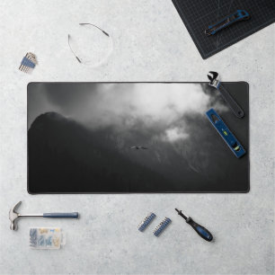 The raven above mountains desk mat