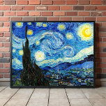 The Starry Night by Vincent Van Gogh  Poster<br><div class="desc">The painting is dominated by a moon- and star-filled night sky. It takes up three-quarters of the picture plane and appears turbulent, even agitated, with intensely swirling patterns that seem to roll across its surface like waves. It is pocked with bright orbs—including the crescent moon to the far right, and...</div>