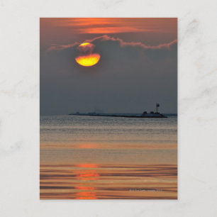 The sun emerges through an off-shore fog bank postcard