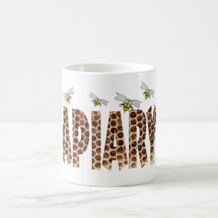 The word apiary with an overlay of honeycomb and b coffee mug