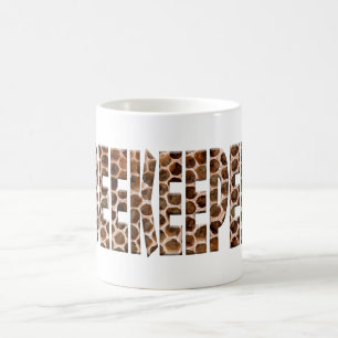 The word beekeeper with an overlay of honeycomb.   coffee mug