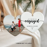 The Year We Got Engaged Names & Photo Ceramic Tree Decoration<br><div class="desc">Personalised engagement Christmas ornament with custom photo, a meaningful keepsake for couples celebrating the year they got engaged. The heart-shaped ornament features the phrase “The Year We Got Engaged” in elegant script paired with classic serif text for names and the year, creating a timeless and romantic look. The minimalist black...</div>
