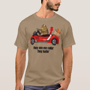 They see me rollin they hatin cat in a car T-Shirt