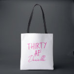 THIRTY AF Personalised Funny 30th Birthday Tote Bag<br><div class="desc">Celebrate turning 30 in bold style with this personalised “THIRTY AF” tote bag. Featuring vibrant pink text and your custom name in elegant script, this playful yet practical bag is perfect for birthday brunches, party essentials, or gift-giving flair. Whether you’re treating yourself or surprising your bestie, this tote adds sass...</div>
