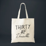 THIRTY AF Personalised Funny 30th Birthday Tote Bag<br><div class="desc">This personalised “THIRTY AF” tote bag is the ultimate 30th birthday accessory — bold, fun, and fabulously functional. Featuring a custom name in elegant script beneath the playful slogan, it’s perfect for brunches, gifting, errands, or that post-party coffee run. Made for birthdays with attitude, this bag is as stylish as...</div>