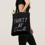 THIRTY AF Personalised Funny 30th Birthday Tote Bag<br><div class="desc">This personalised “THIRTY AF” tote bag is the ultimate 30th birthday accessory — bold, fun, and fabulously functional. Featuring a custom name in elegant script beneath the playful slogan, it’s perfect for brunches, gifting, errands, or that post-party coffee run. Made for birthdays with attitude, this bag is as stylish as...</div>