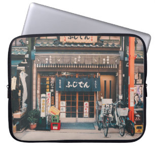THREE BICYCLES PARKED IN FRONT OF BUILDING LAPTOP SLEEVE
