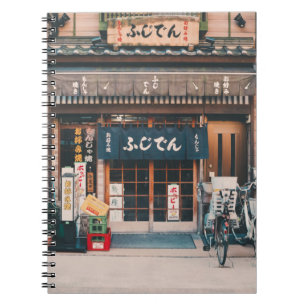 THREE BICYCLES PARKED IN FRONT OF BUILDING NOTEBOOK