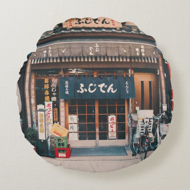 THREE BICYCLES PARKED IN FRONT OF BUILDING ROUND CUSHION (Front)