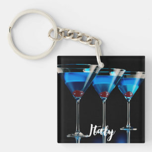 Three blue cocktails with cherry on black key ring
