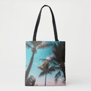 Three coconut trees on seashore tote bag