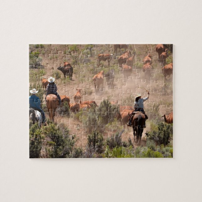 Three cowboys and cowgirls driving cattle jigsaw puzzle (Horizontal)
