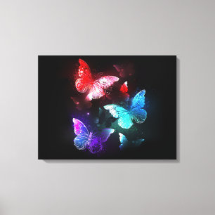 Three Glowing Butterflies on night background Canvas Print