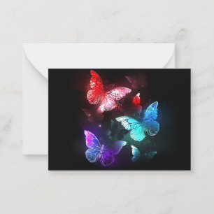 Three Glowing Butterflies on night background Card