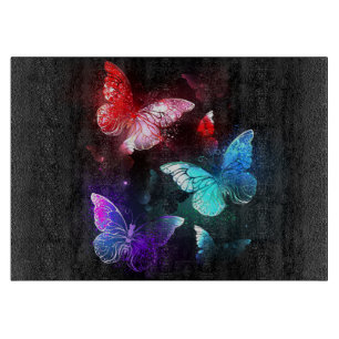 Three Glowing Butterflies on night background Cutting Board