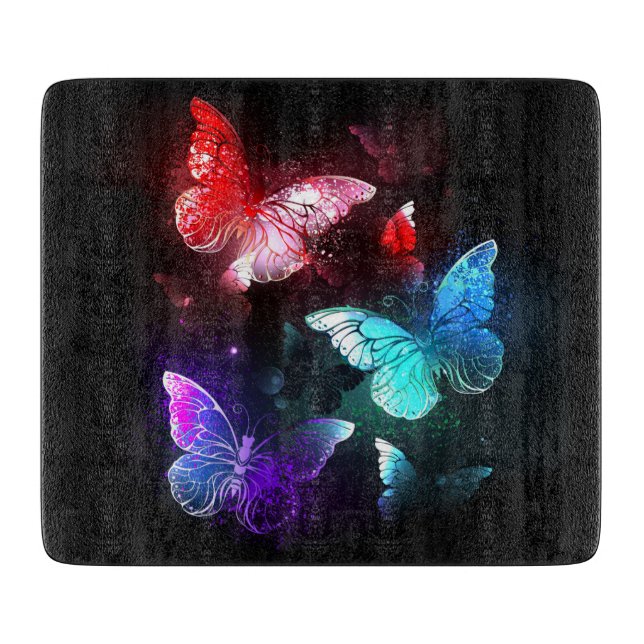 Three Glowing Butterflies on night background Cutting Board (Front)
