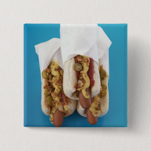 Three hot dogs in buns 15 cm square badge