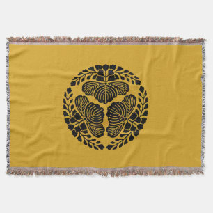 Three paulownia blooms, heads facing outward throw blanket