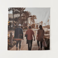 Three persons walking near palm trees