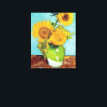 Three Sunflowers | Vincent van Gogh Canvas Print<br><div class="desc">Three Sunflowers (1888) by Vincent van Gogh is a vibrant still life that showcases the artist’s signature thick brushstrokes and bold use of color. The painting features three sunflowers in a simple vase, their golden petals contrasting against the aqua blue background. Van Gogh's vivid yellow palette brings energy and life...</div>