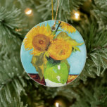 Three Sunflowers | Vincent van Gogh Ceramic Tree Decoration<br><div class="desc">Three Sunflowers (1888) by Vincent van Gogh is a vibrant still life that showcases the artist’s signature thick brushstrokes and bold use of colour. The painting features three sunflowers in a simple vase, their golden petals contrasting against the aqua blue background. Van Gogh's vivid yellow palette brings energy and life...</div>