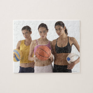 three women of different race, holding jigsaw puzzle