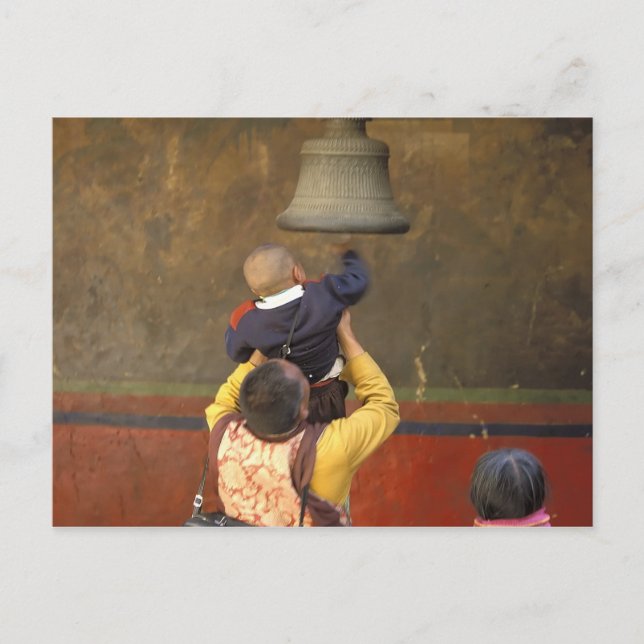 Tibetan Buddhist monk lifting a boy to ring a Postcard (Front)