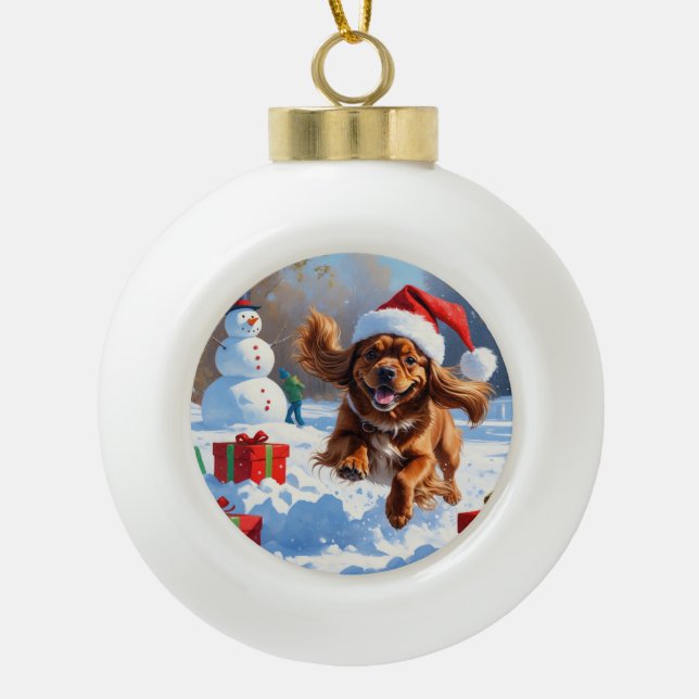 Tibetan Spaniel Running in Snow with Christmas Hat Ceramic Ball Christmas Ornament (Front)