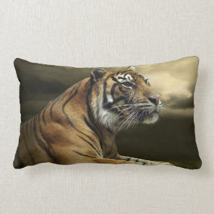 Tiger looking and sitting under dramatic sky lumbar cushion