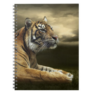 Tiger looking and sitting under dramatic sky spiral notebook