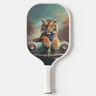 Tiger sitting on a sports car pickleball paddle