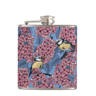 Tit birds in the lilac garden hip flask