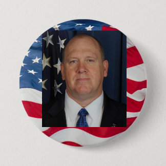 Tom Homan Button with flag waving behind