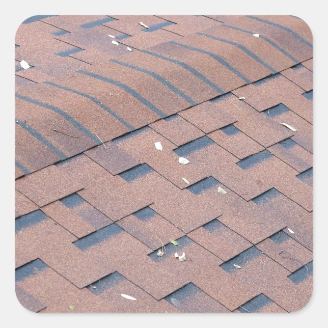 Top view of brown roof shingles with a few fallen square sticker (Front)