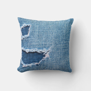 Torn denim fabric texture, blue hues. cushion