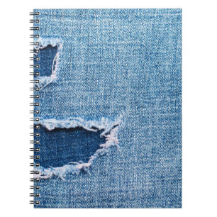 Torn denim fabric texture, blue hues. notebook