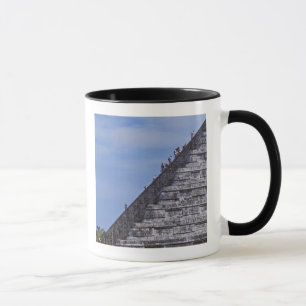 Tourists climbing stairs on ruins of El Mug