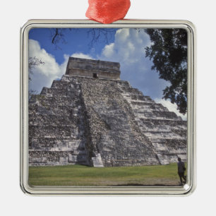 Tourists walk past an unrestored side of El 2 Metal Tree Decoration