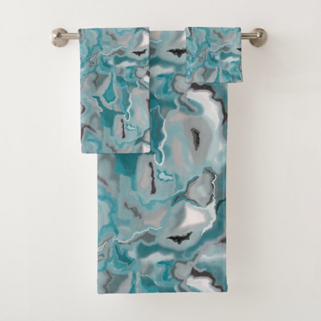 Towel with a turquoise grey abstract pattern. (Insitu)
