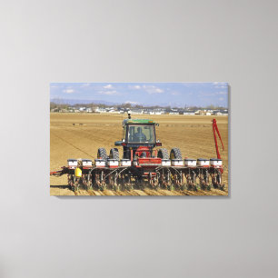 Tractor pulling a seed corn planter. canvas print