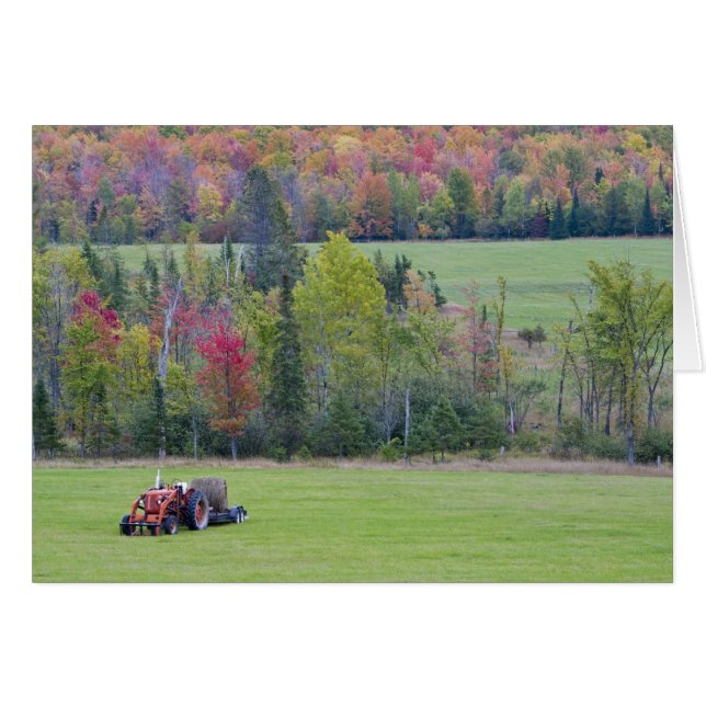 Tractor with hay bale in green field with (Front Horizontal)