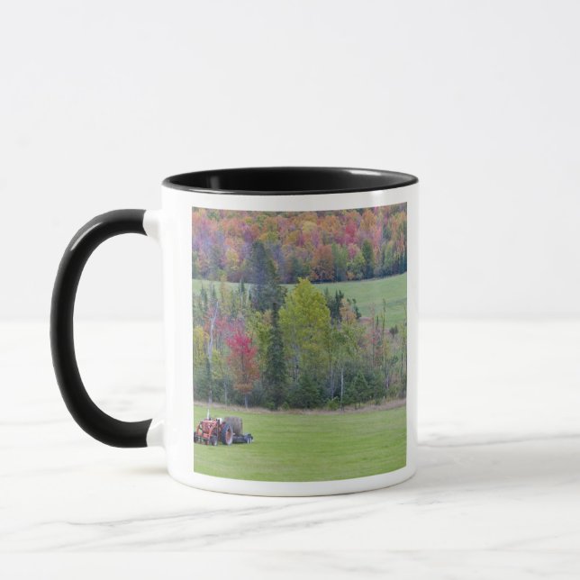 Tractor with hay bale in green field with mug (Left)
