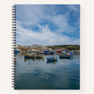 Traditional colorful fishing boats in the harbor notebook